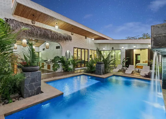 Modern Home With Chic Bohemian Style And Zen Outdoor Oasis With Swimming Pool And Tiki Style Dining Space