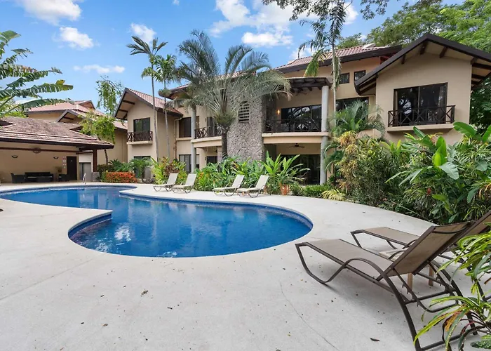 Modern Island-Themed Condo With Floor-To-Ceiling Windows & Garden And Pool Views Within Walking Distance Of The Beach